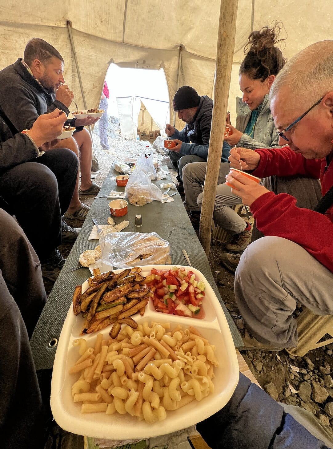 Climbers training at Mount Ararat camp preparing for high-altitude ascent with tents and mountain backdrop